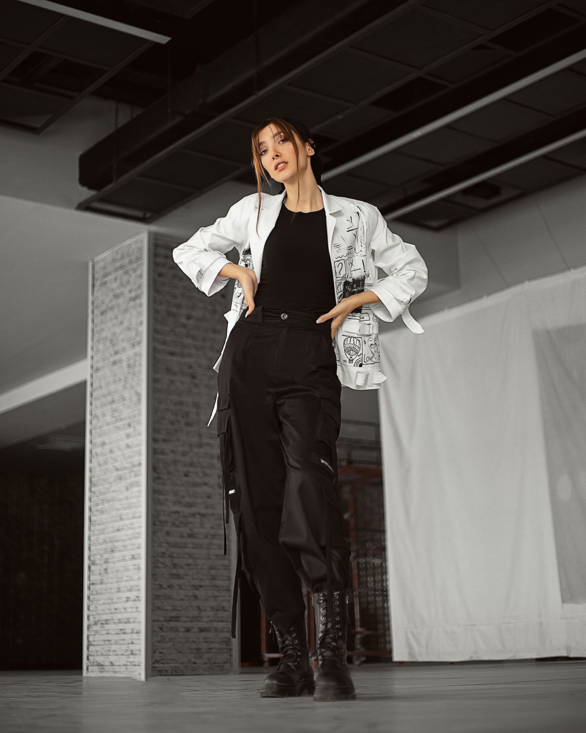 Modern style woman in trendy outfit posing inside an urban setting. Chic and confident vibe.