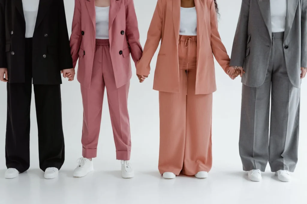 Women wearing elegant suit sets and modern dresses at AJ Vogue clothing store featuring stylish outfits for women and trending fashion.